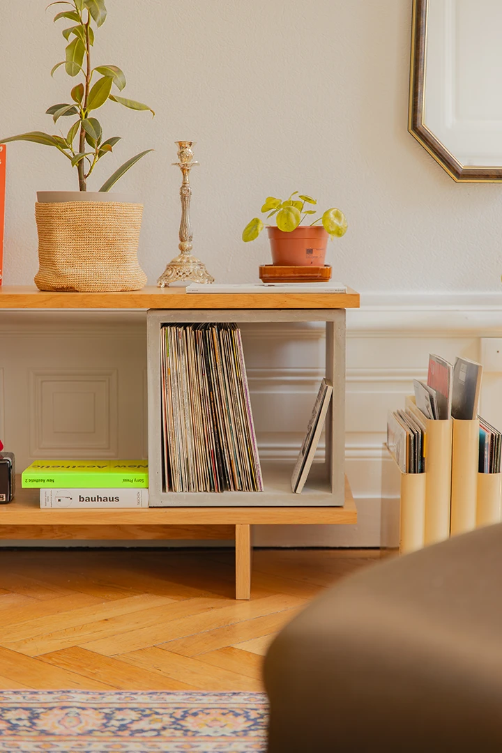 concrete and oak veneer furniture with plants and vinyl records